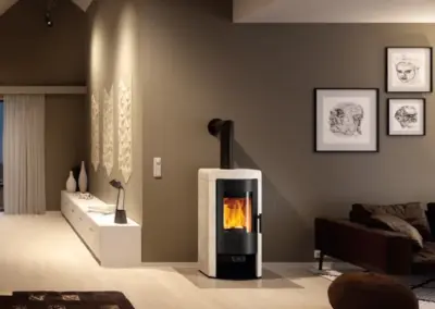 RIKA NEX Kaminofen mit schlankem Korpus, großer Sichtscheibe und sichtbarem Feuer.
