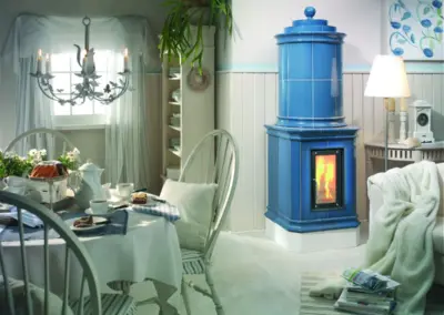 Klassischer Kachelofen mit Verkleidung und Turm aus blauer Ofenkeramik.